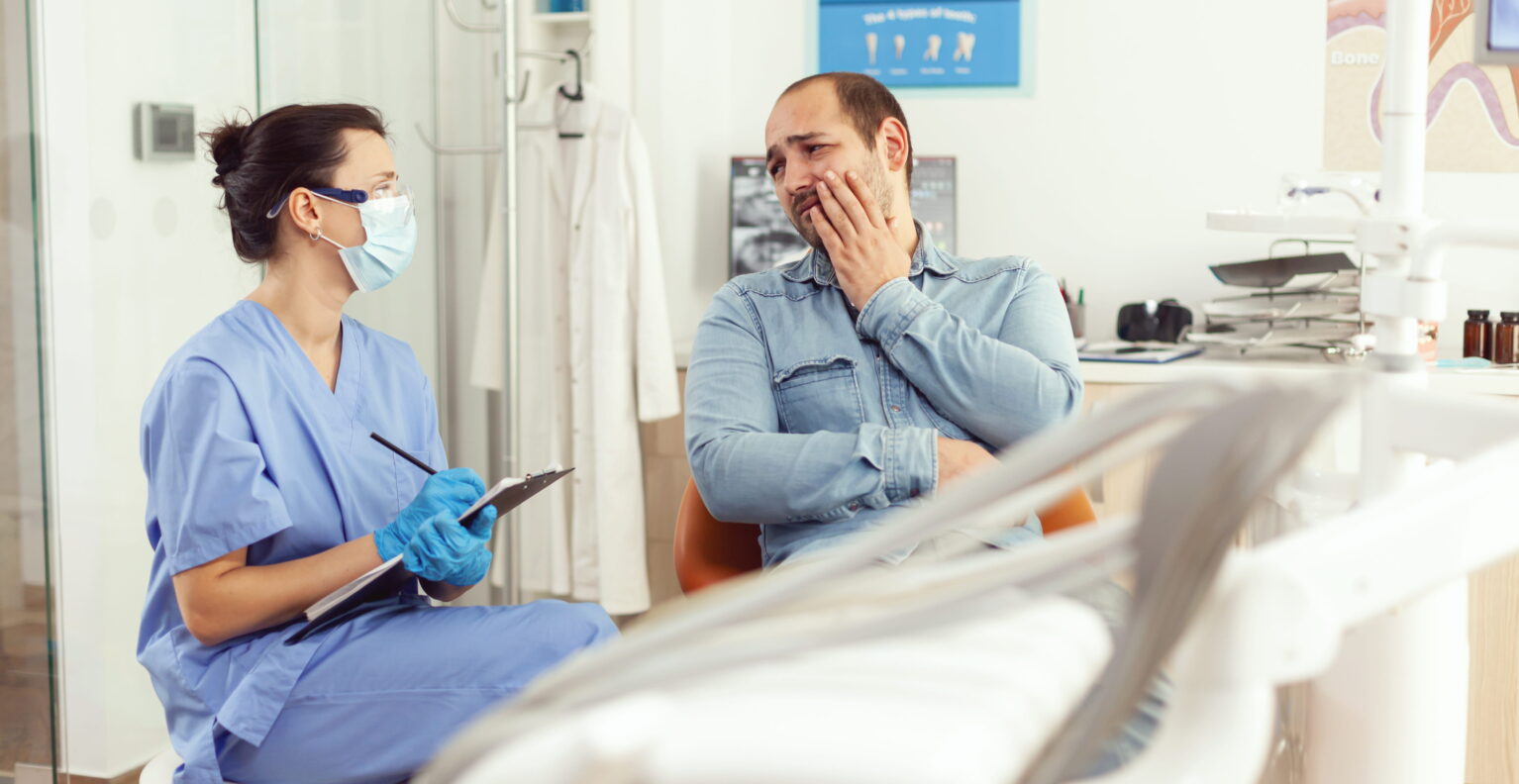 Dentist in Taylor TX examining patient for TMJ jaw pain treatment